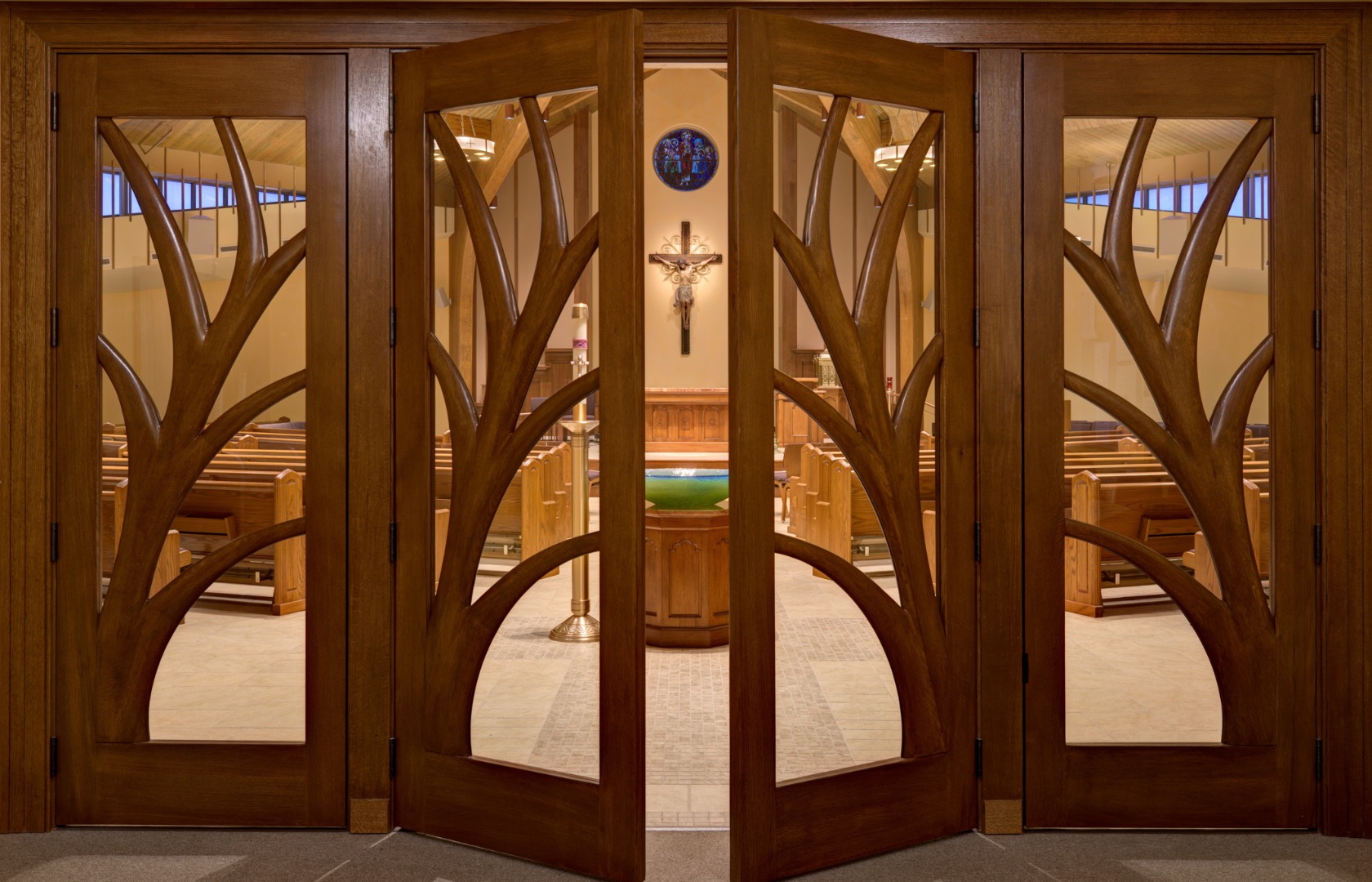 New custom-designed carved wood doors to the Worship Space